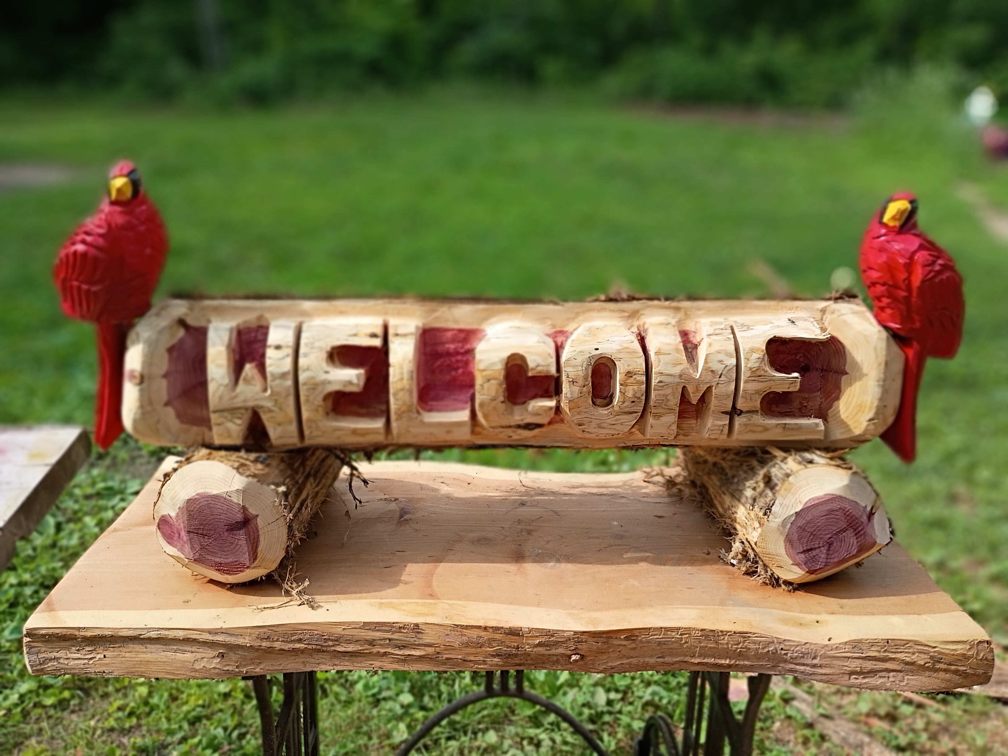 Welcome log with (2) Cardinal Birds