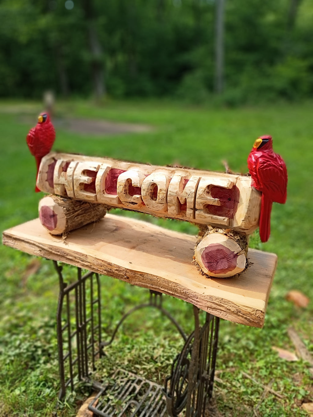 Welcome log with (2) Cardinal Birds