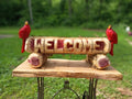 Welcome log with (2) Cardinal Birds